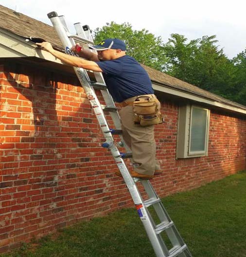 Donnie Seburg, inspecting roof damage after the storm