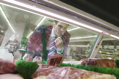 Man looking at meat in store
