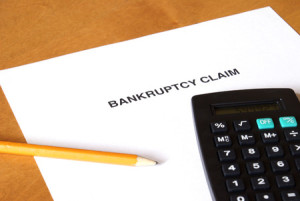 44987093 - a bankruptcy claim form with a calculator and pencil.