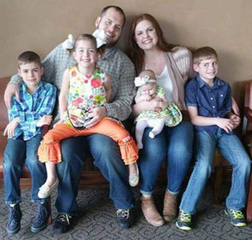 The Combs family, from left, Zeke, Jubilee, Brandon, Sarah with Lilia on her lap, and Titus.