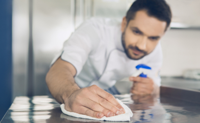 man cleaning commercial kitchen