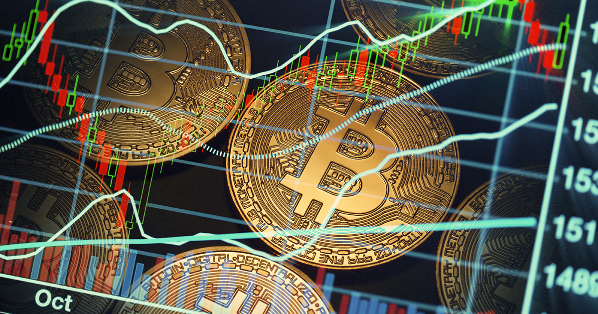 shiny bitcoins with stock market background.