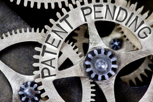 Macro photo of tooth wheel mechanism with PATENT PENDING concept letters