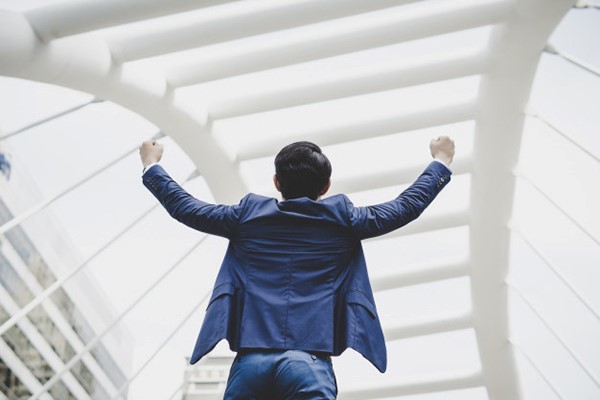 person standing with two arms raised in fists